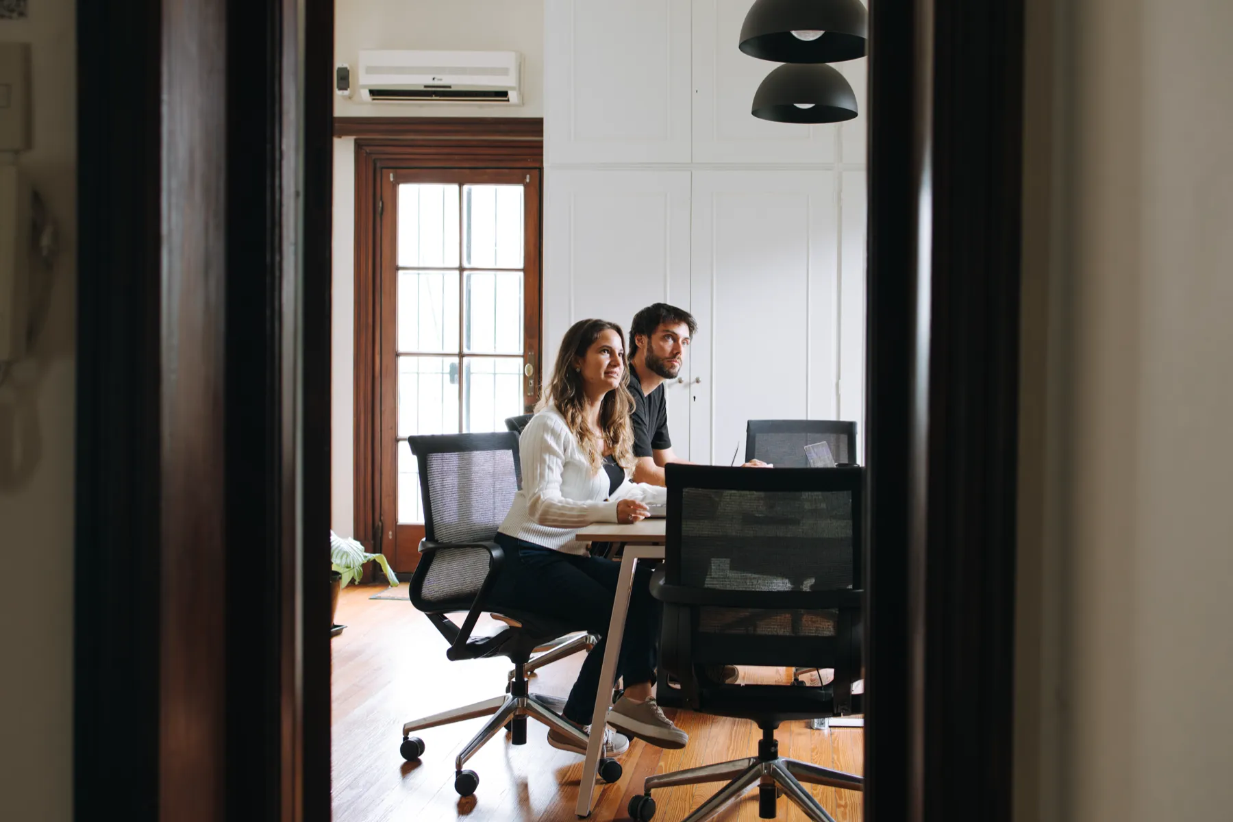Two members of the team working side by side at Thaloz House