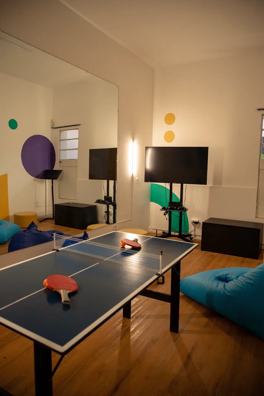 The rec room at Thaloz House, with a ping-pong table and lounge seating