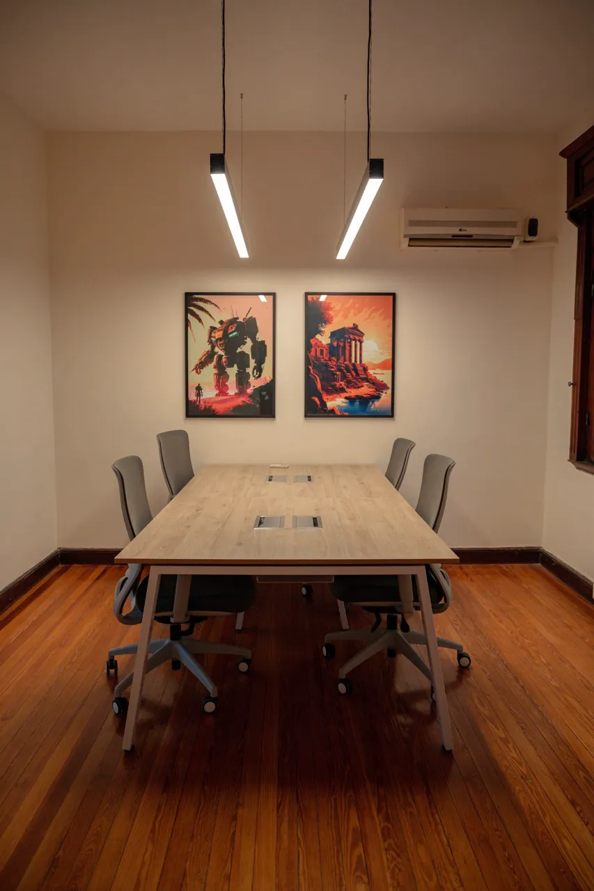 The meeting room at Thaloz House, a long table under pendant lights
